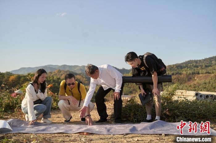 单霁翔(右二)带领韩雪(左一)、黄觉(左二)和马伯骞(右一)查看地图寻找良渚的水坝遗址。节目组供图